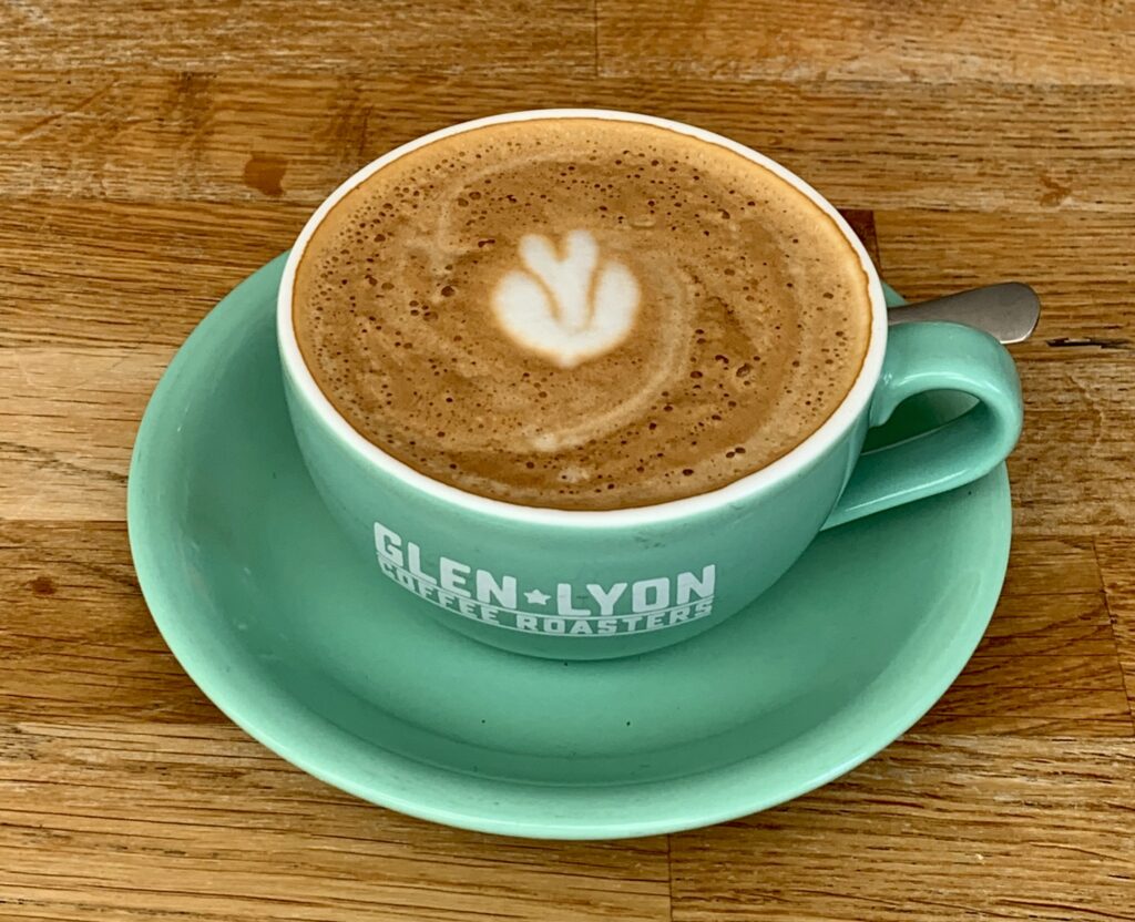 Green coffee cup full of coffee